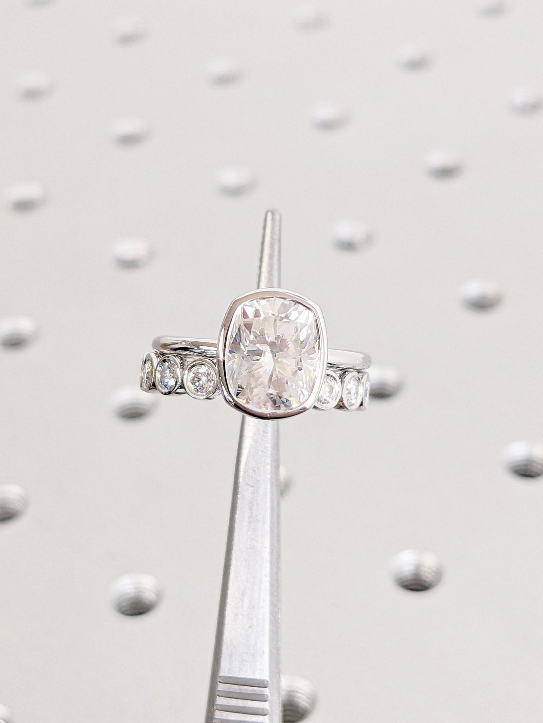 Detailed close-up of cushion bezel diamond engagement ring