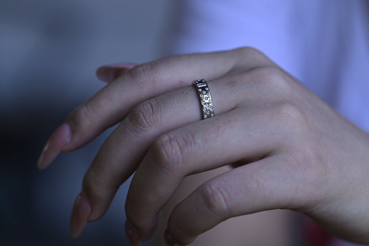 Side view of round & emerald diamond wedding band