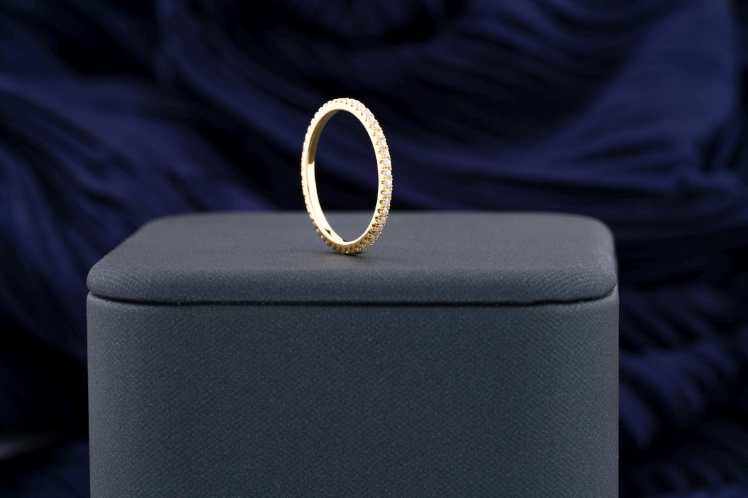 Round diamond band stacked with engagement ring
