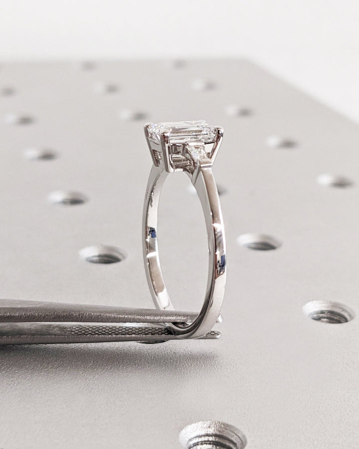 Emerald three stone engagement ring close-up showing high clarity diamond clarity