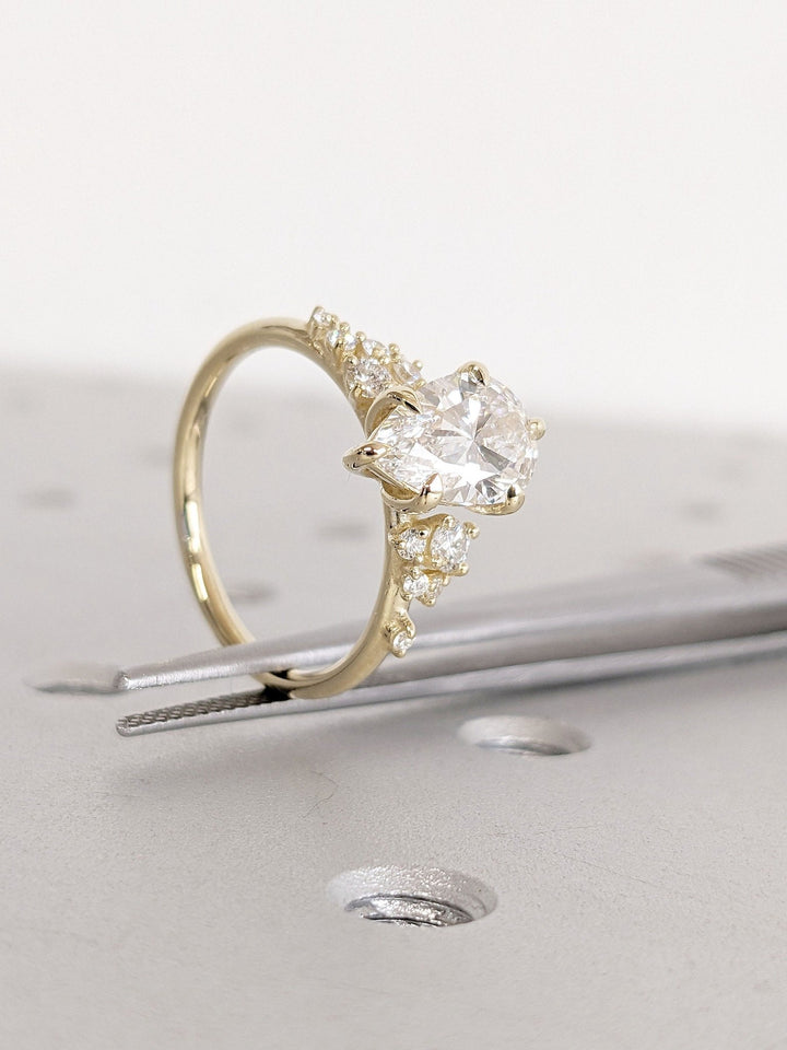 Angled view of pear cut diamond in cluster setting