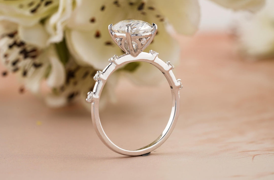 Oval pave diamond ring displayed on jewelry stand
