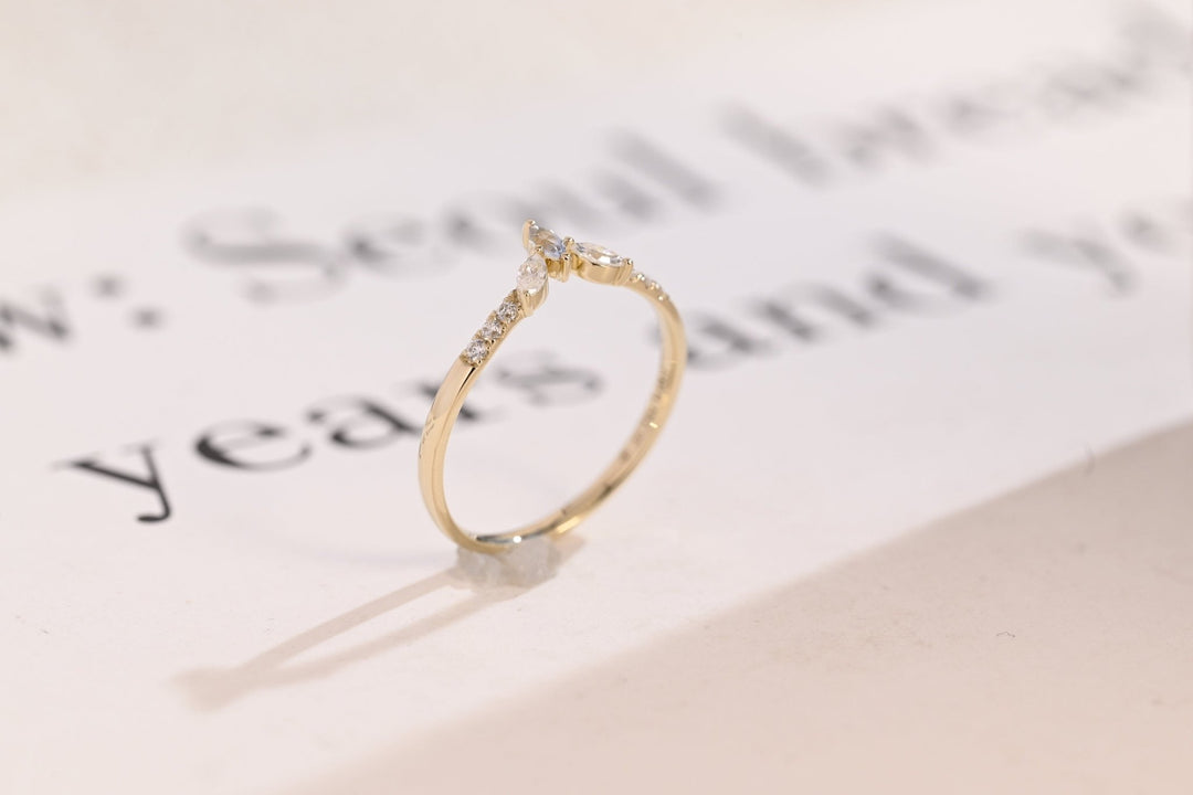 Side view of marquise & round diamond wedding band