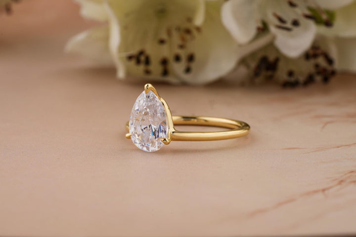 Pear solitaire engagement ring viewed from the side