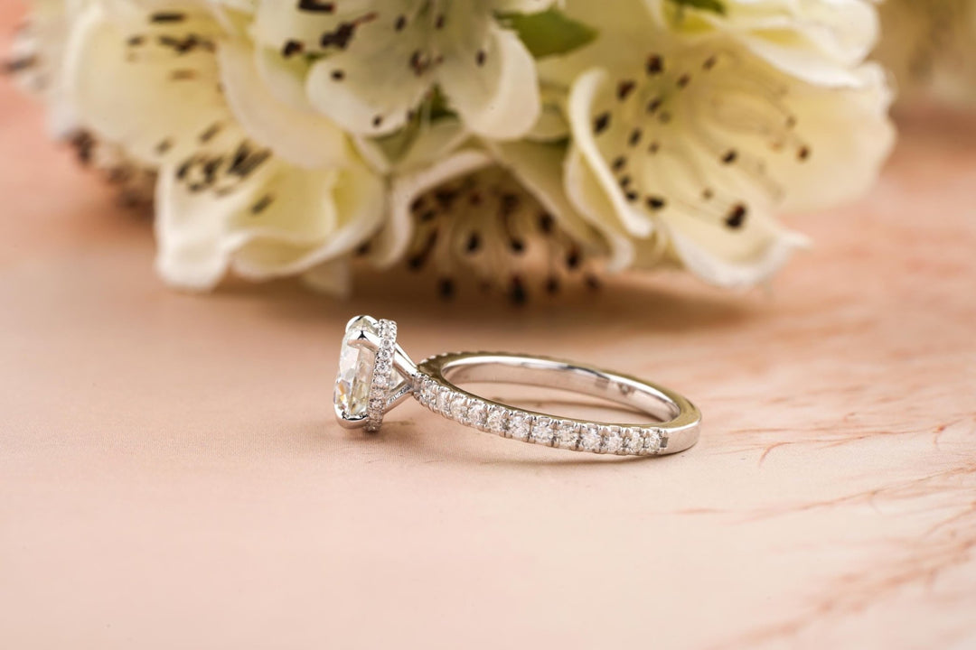 Round hidden halo engagement ring viewed from the side