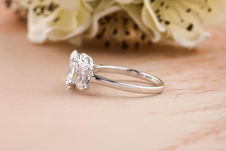 Oval solitaire engagement ring shown on hand for true-to-life sizing