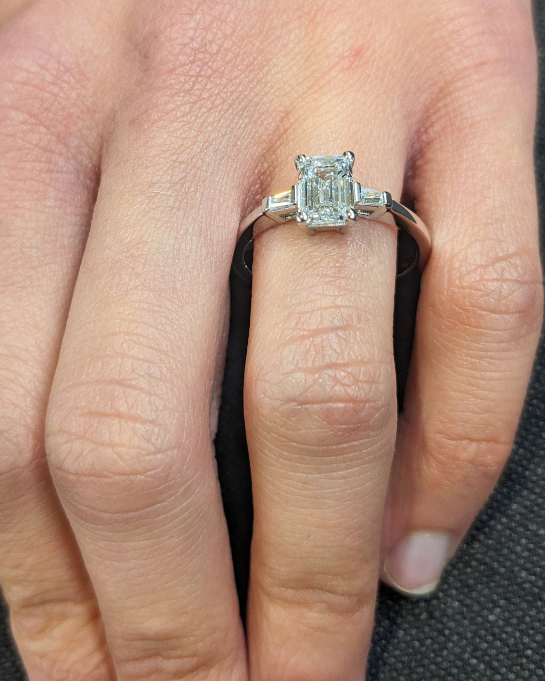 Emerald three stone lab grown diamond ring side profile in gold setting