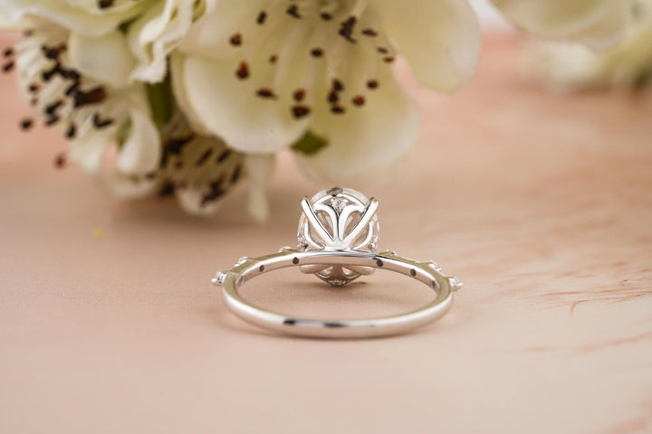 Angled view of oval cut diamond in pave setting