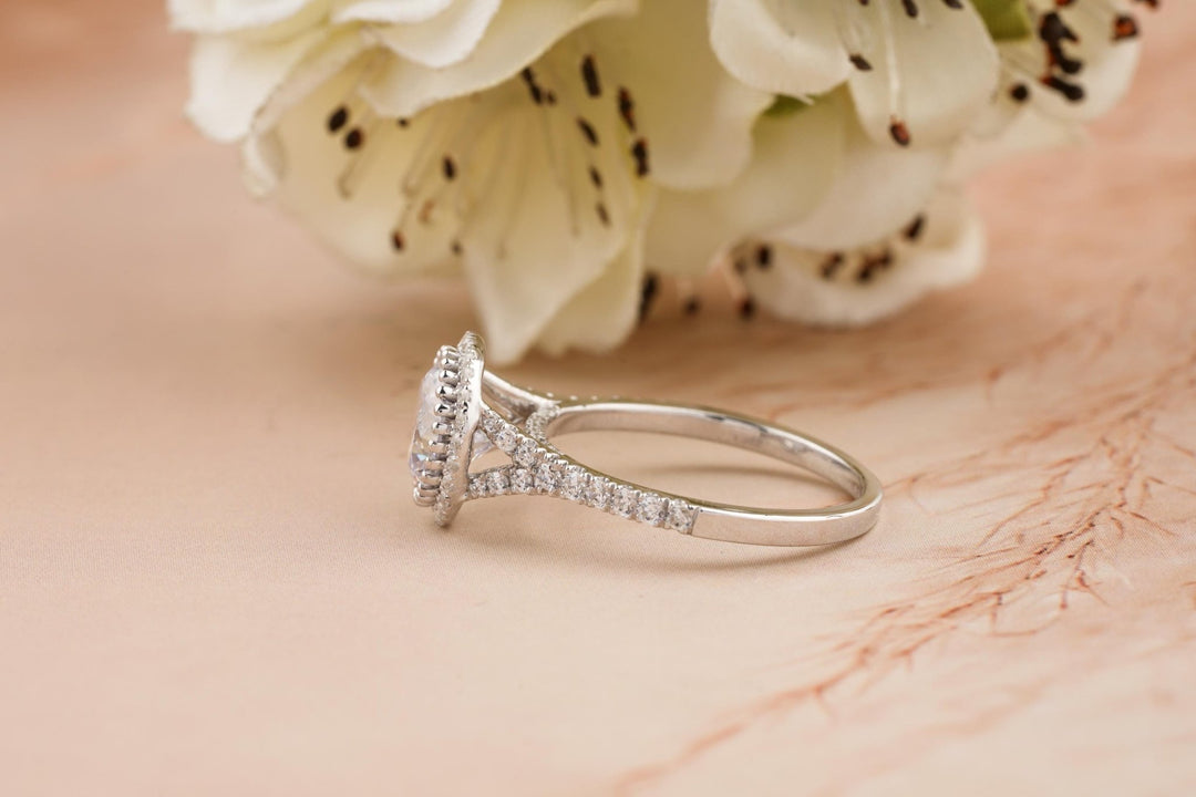 Certified round cut diamond featured in split shank engagement ring