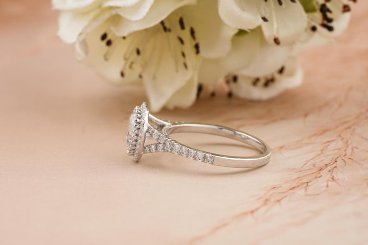 Certified round cut diamond featured in split shank engagement ring