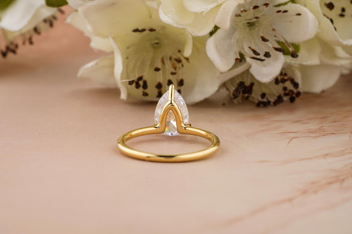 Pear solitaire lab grown diamond ring fitted on finger