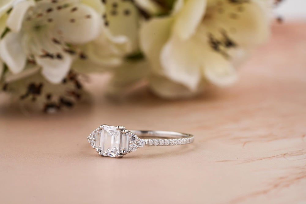 Emerald solitaire engagement ring close-up highlighting diamond sparkle