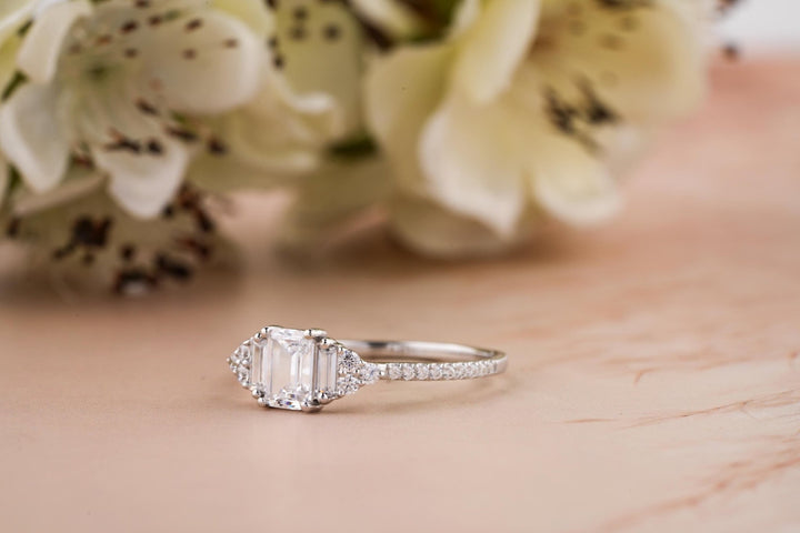 Emerald solitaire engagement ring close-up highlighting diamond sparkle