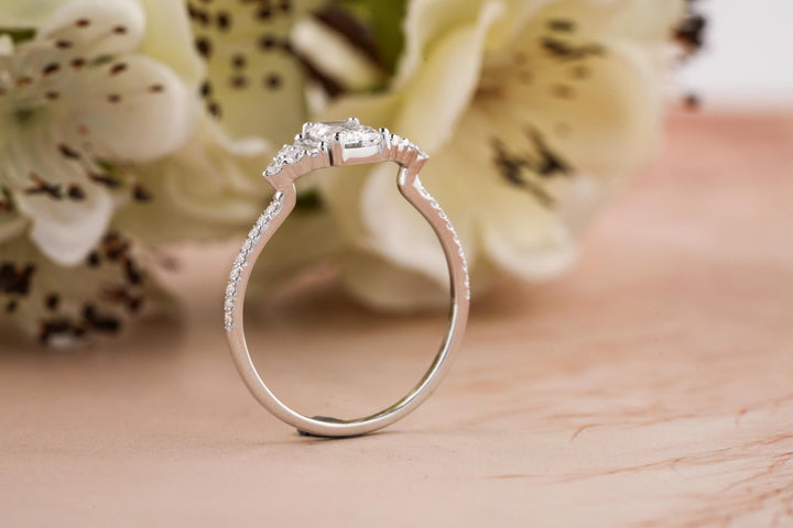 Detailed close-up of emerald solitaire diamond engagement ring