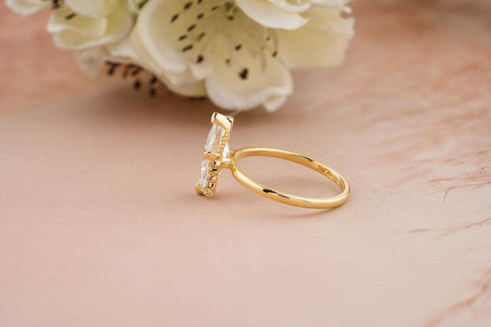 Certified marquise cut diamond featured in cluster engagement ring