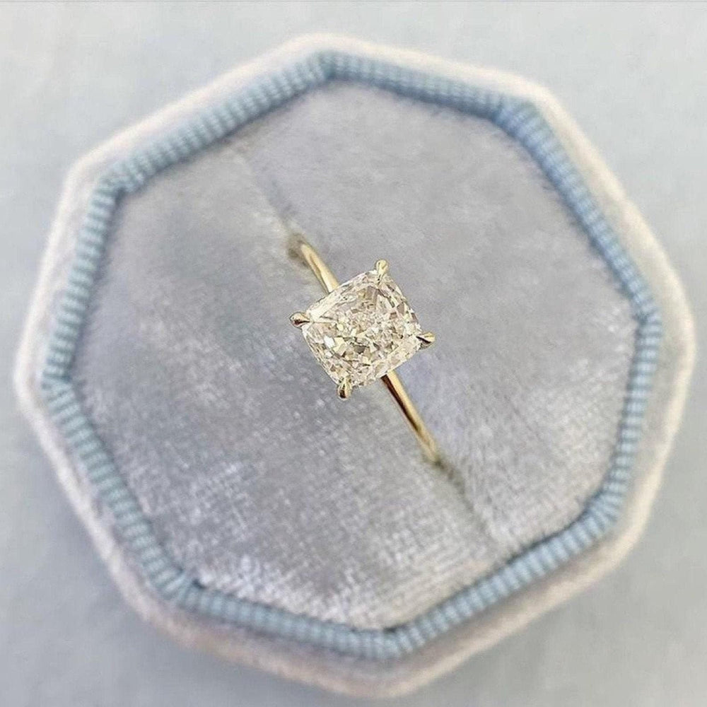 Cushion solitaire diamond ring displayed on jewelry stand