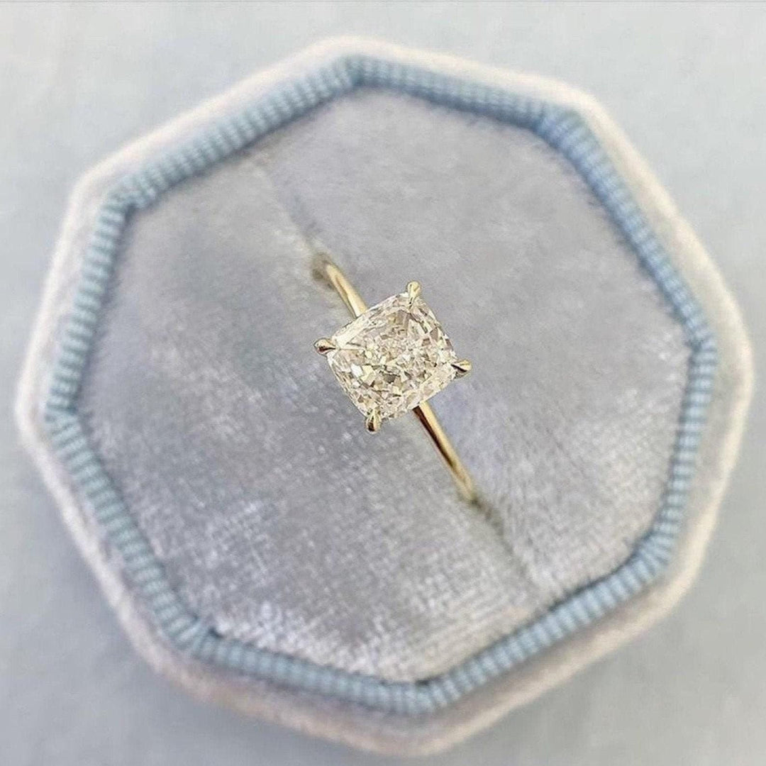 Cushion solitaire diamond ring displayed on jewelry stand