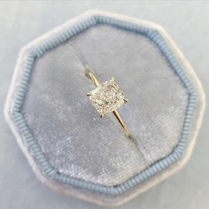 Cushion solitaire diamond ring displayed on jewelry stand