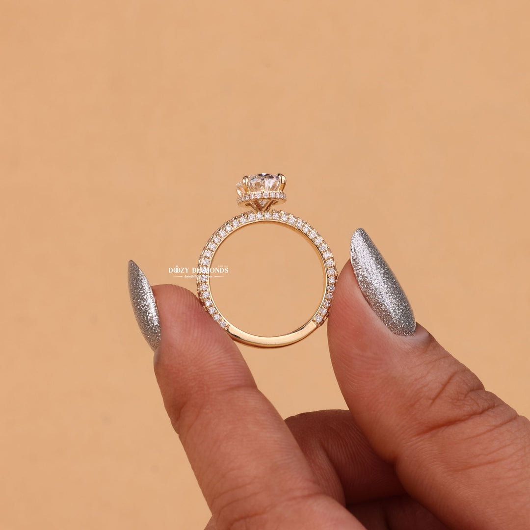 Lifestyle shot of oval hidden halo diamond ring on hand