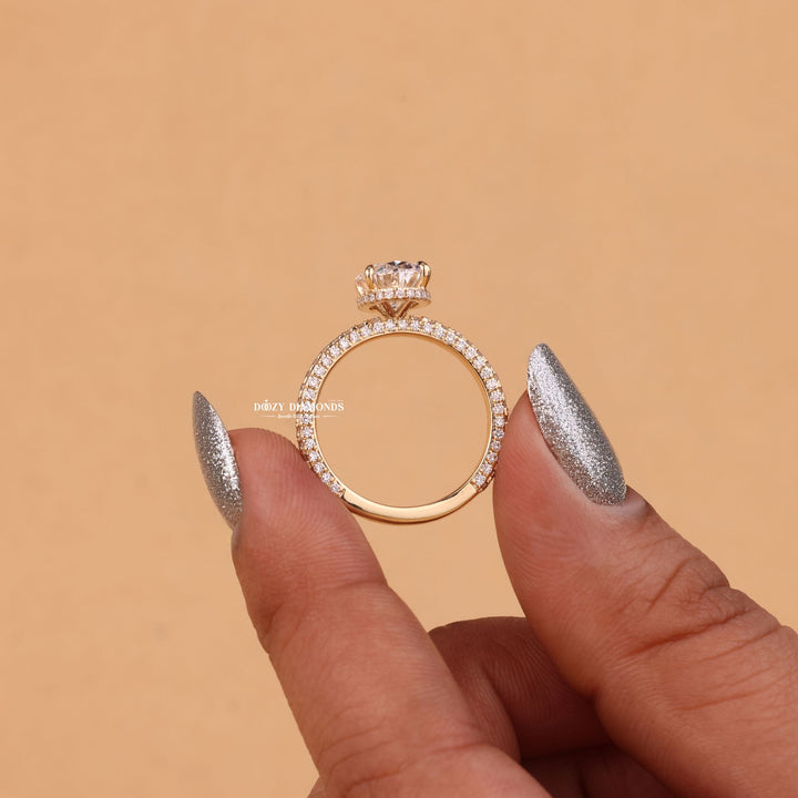 Lifestyle shot of oval hidden halo diamond ring on hand