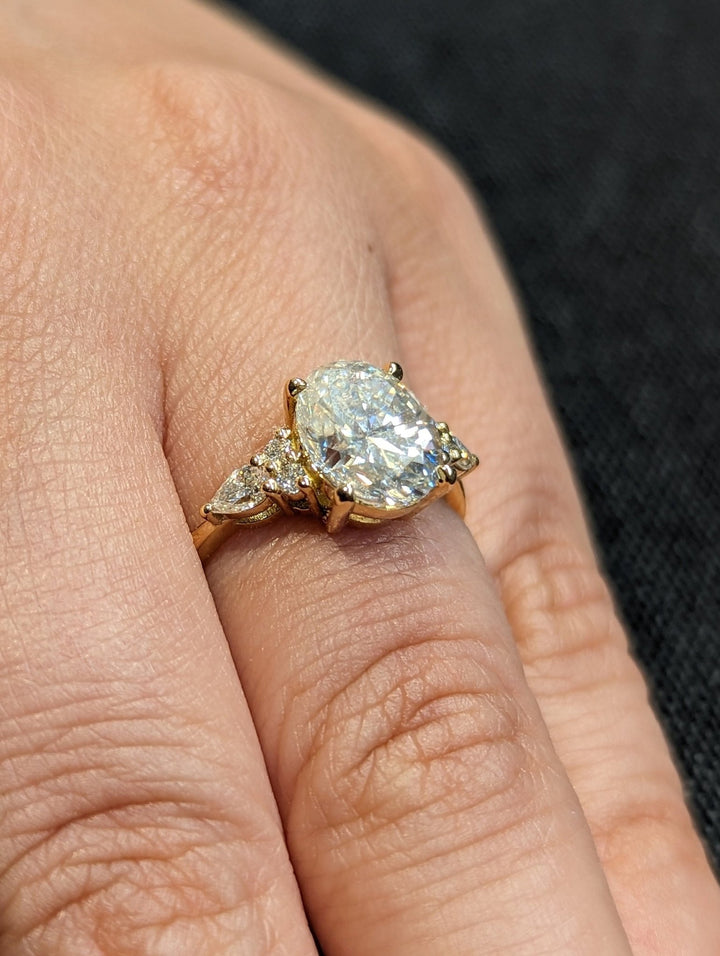 Oval cluster lab grown diamond ring side profile in gold setting
