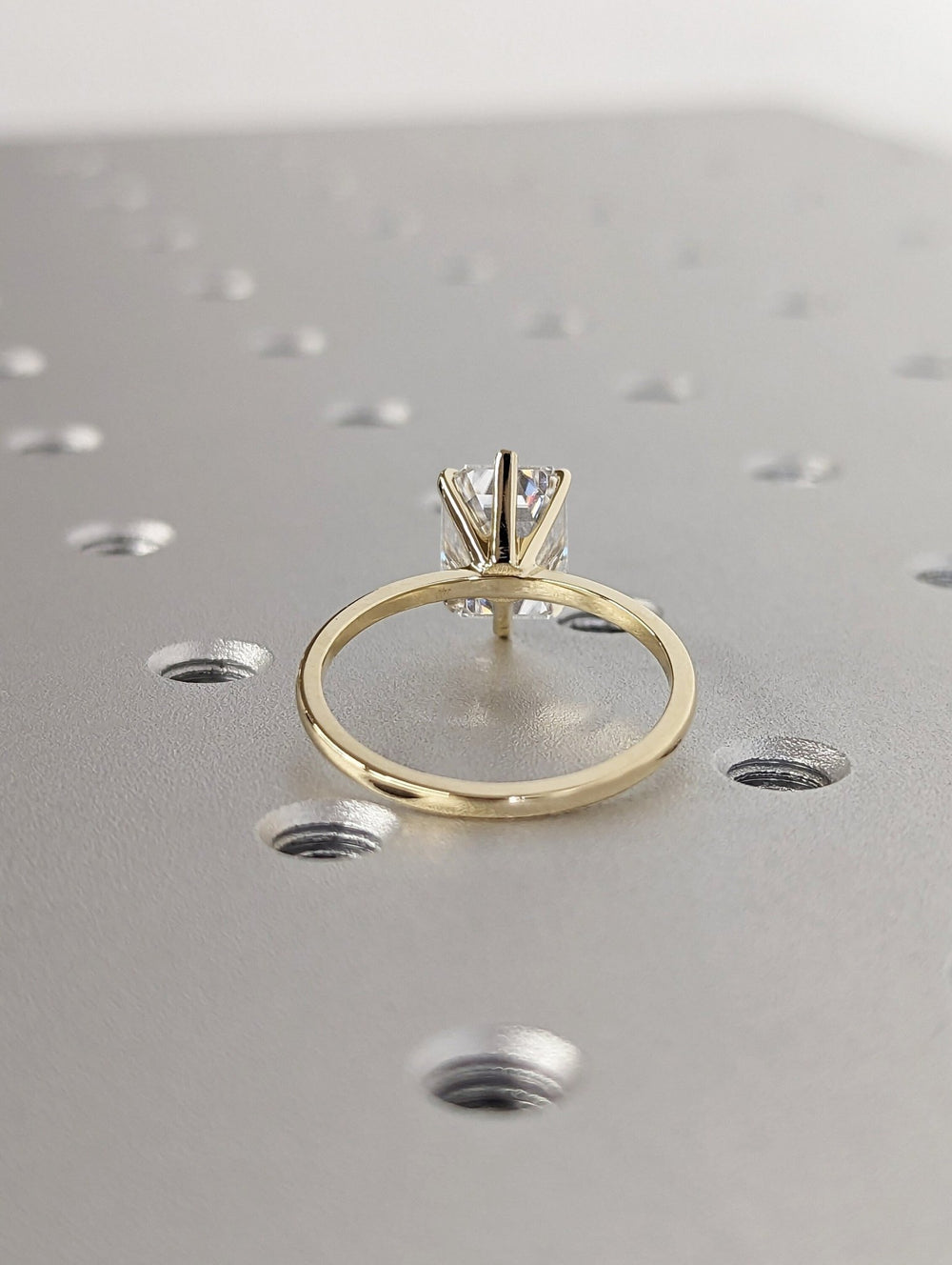 Detailed close-up of emerald solitaire diamond engagement ring