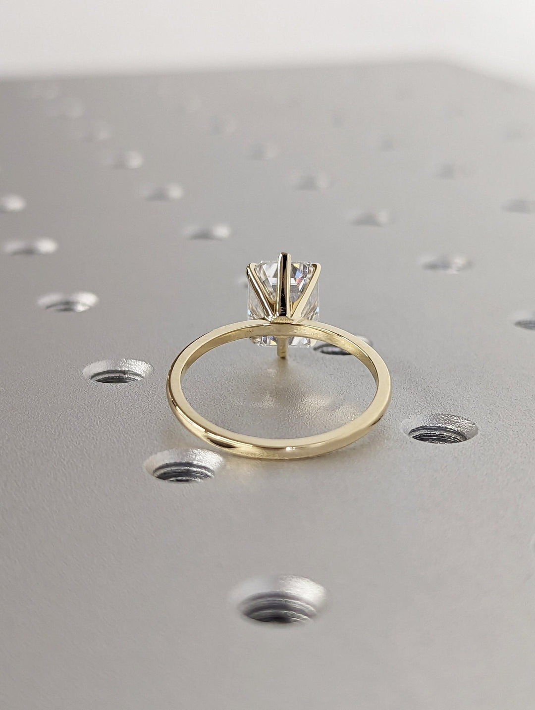 Detailed close-up of emerald solitaire diamond engagement ring