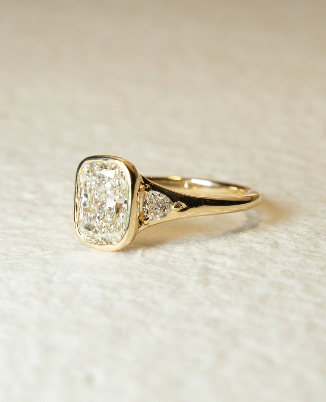 Cushion bezel engagement ring close-up highlighting diamond sparkle