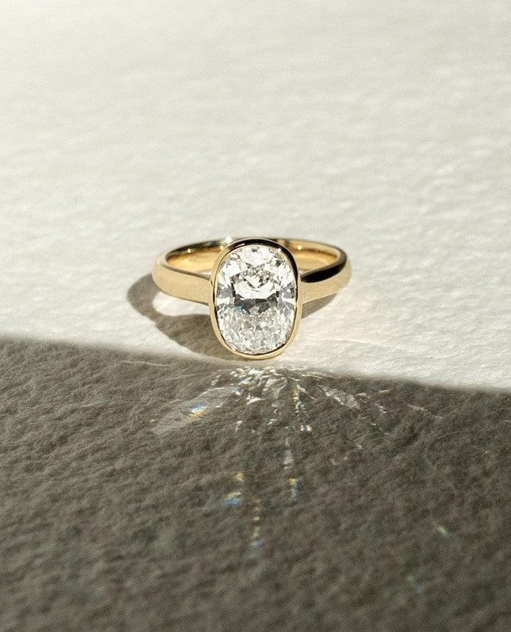 Cushion cut engagement ring shown with authenticity certificate
