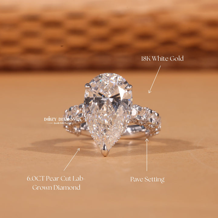 Macro shot of pear cut diamond facets in pave ring setting