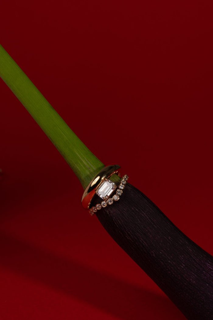 Profile view of emerald cut dome engagement ring band