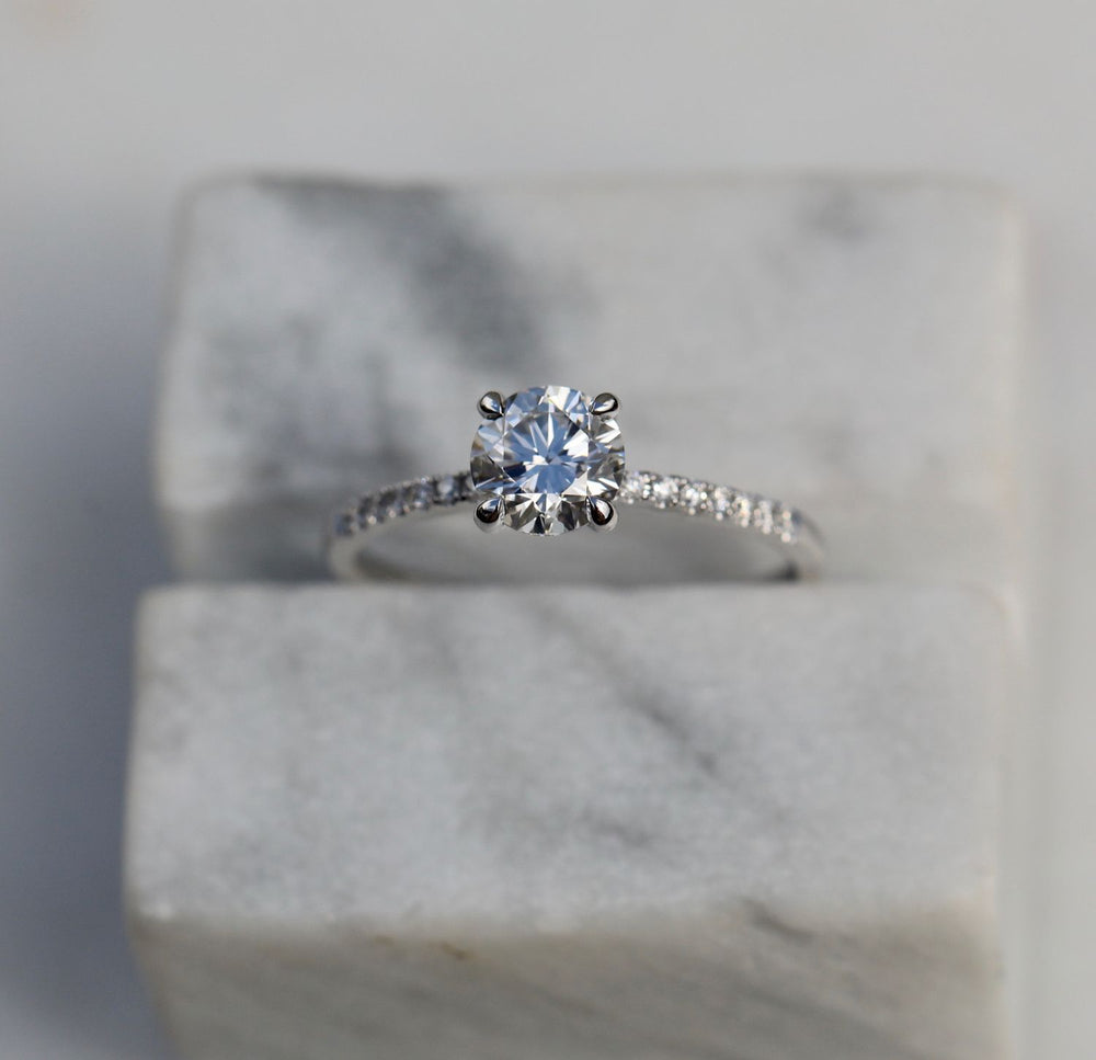 Round solitaire engagement ring close-up highlighting diamond sparkle