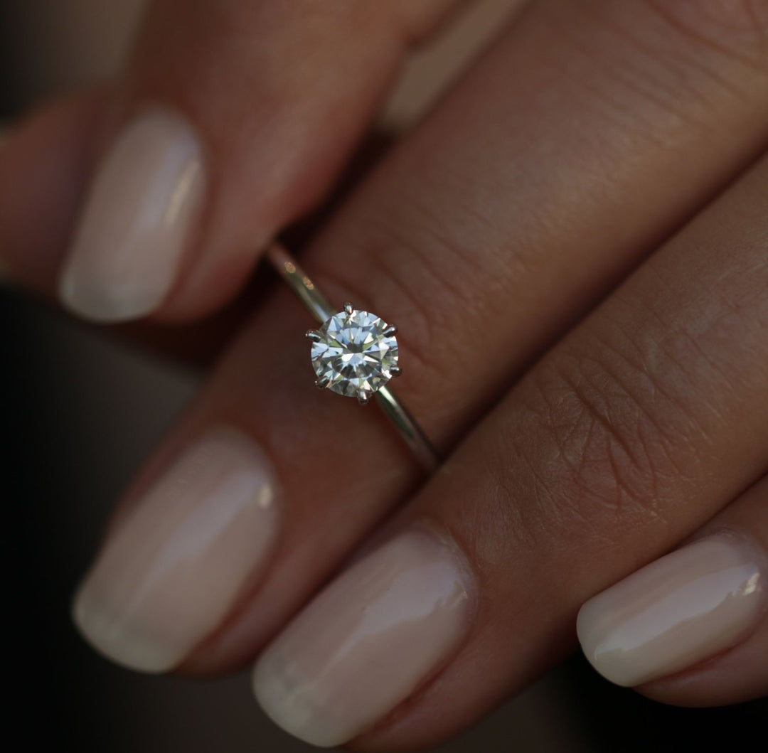 Round solitaire engagement ring offered in gold and platinum