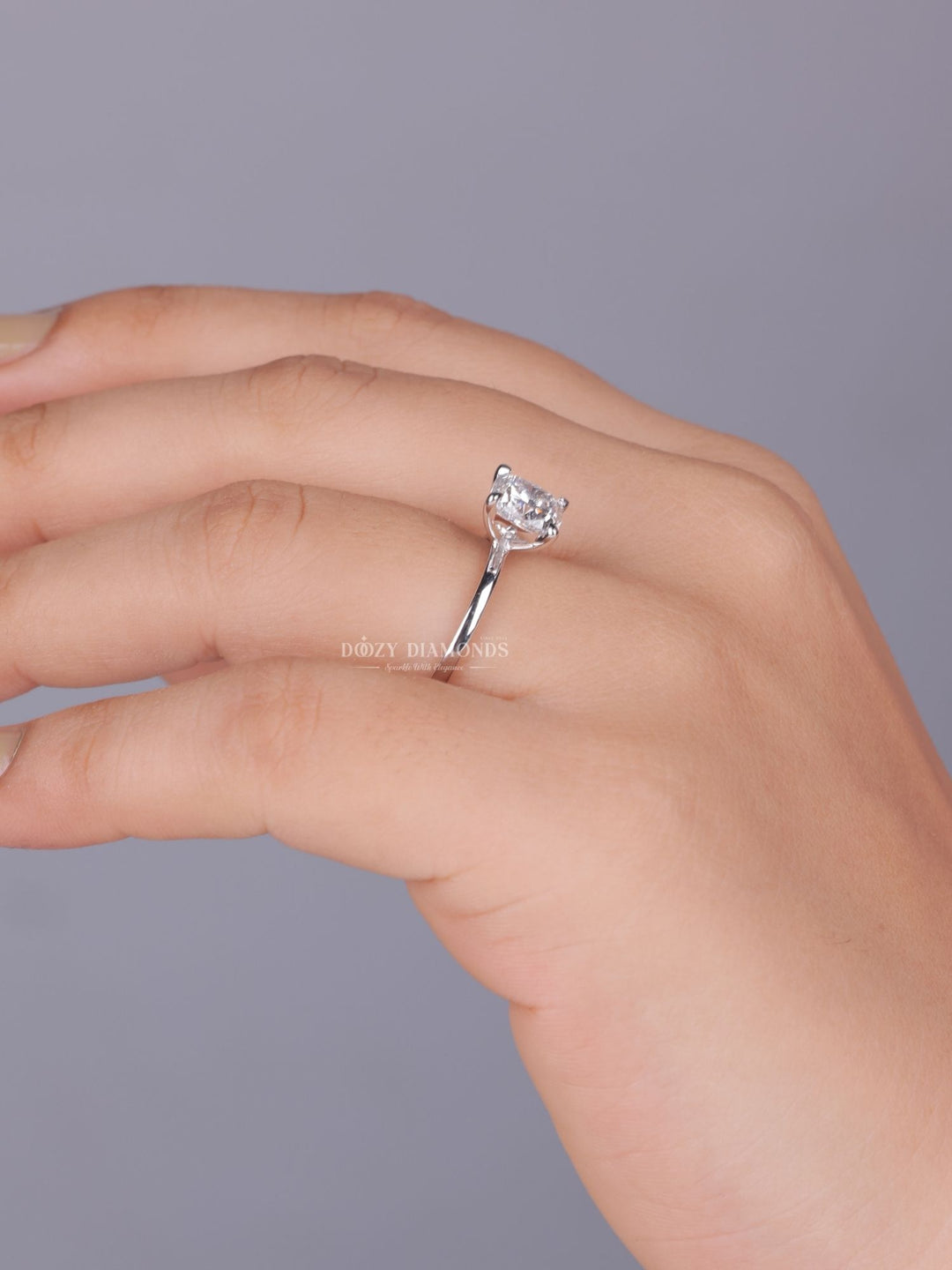 Cushion solitaire engagement ring photographed in natural light