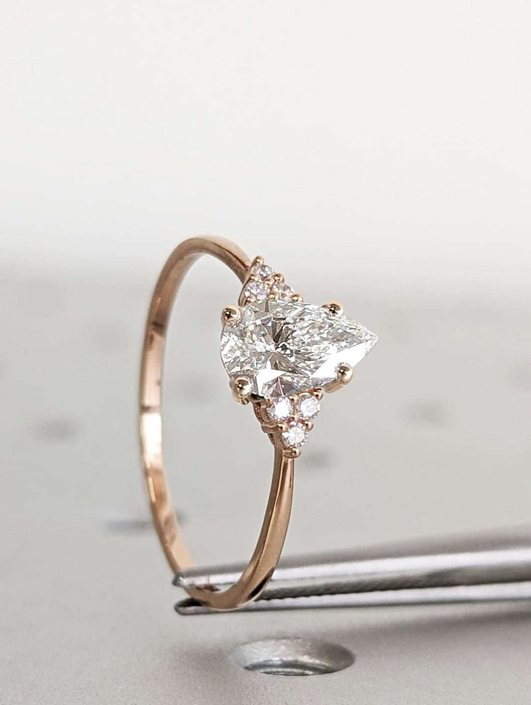 1.0CT pear cut cluster engagement ring available to buy now