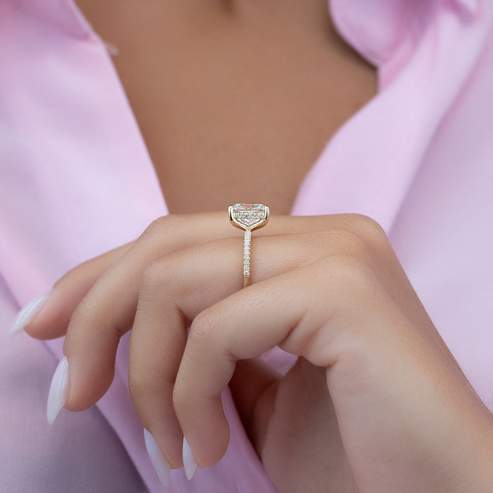 Oval hidden halo engagement ring offered in gold and platinum