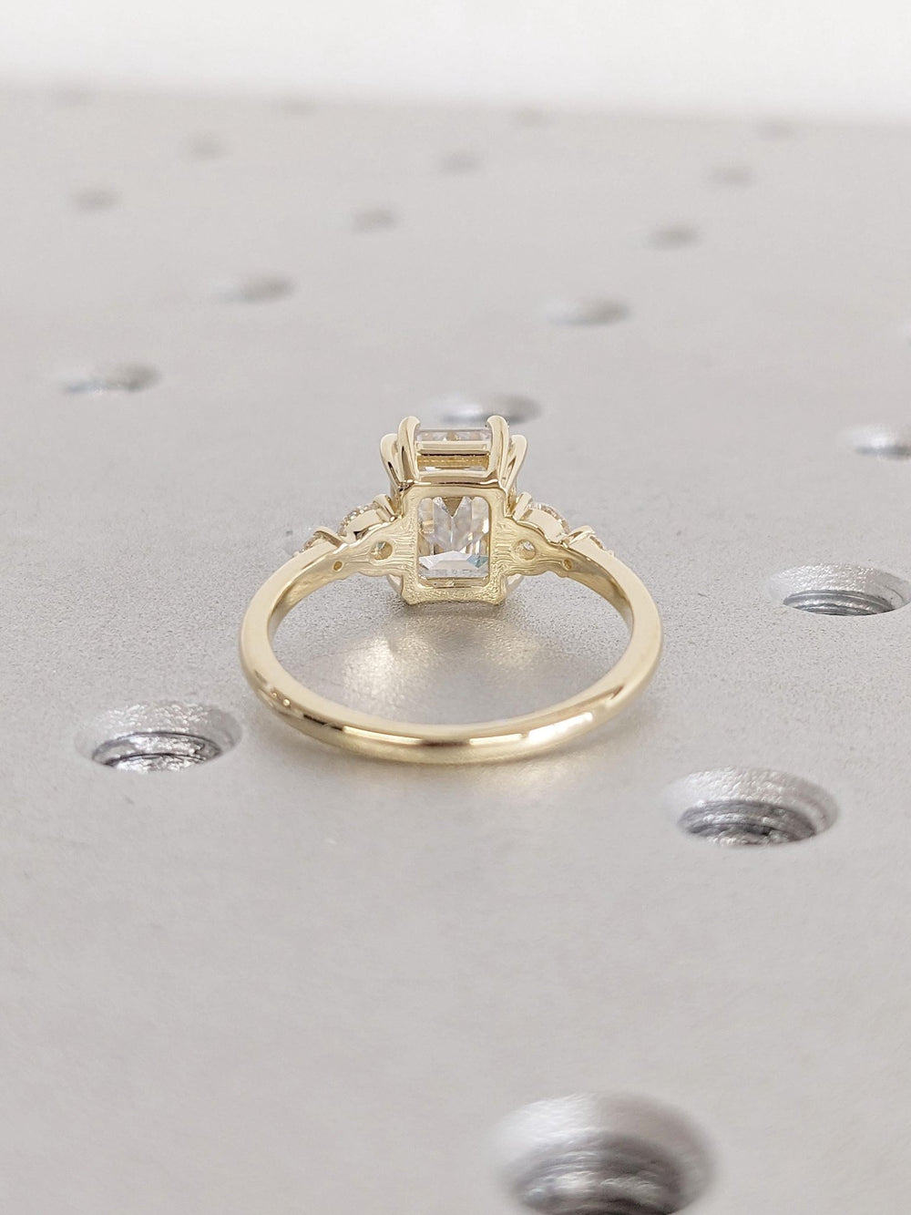 Emerald cluster engagement ring offered in gold and platinum