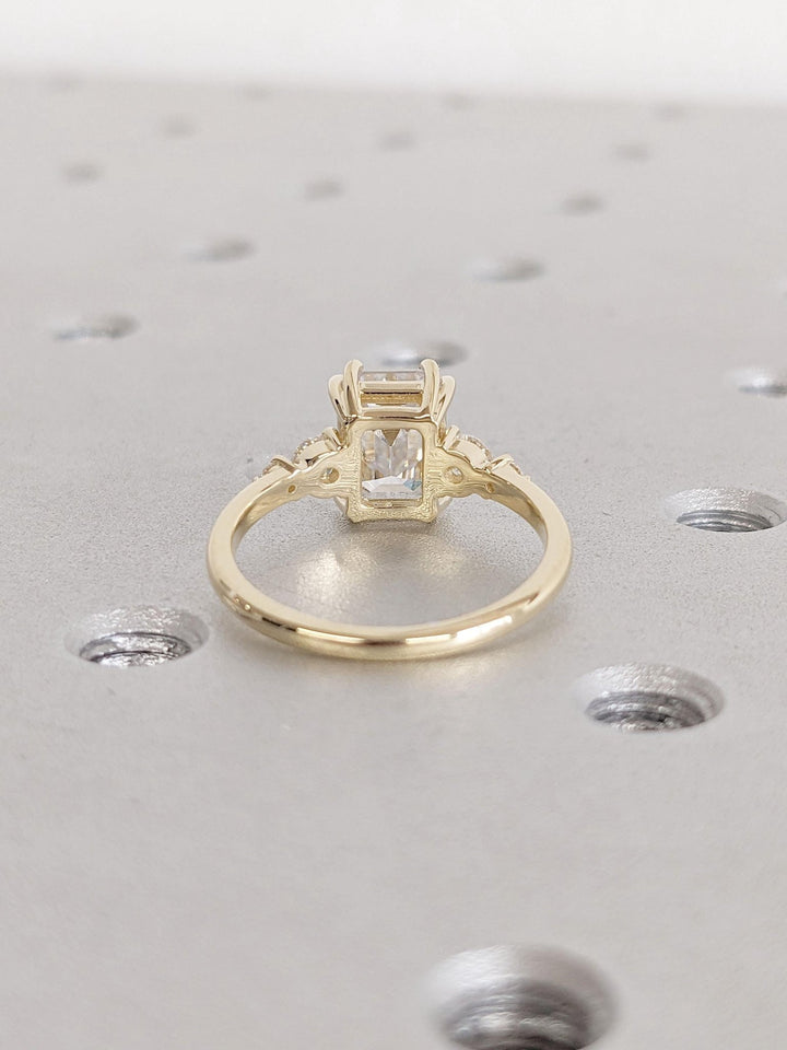 Emerald cluster engagement ring offered in gold and platinum