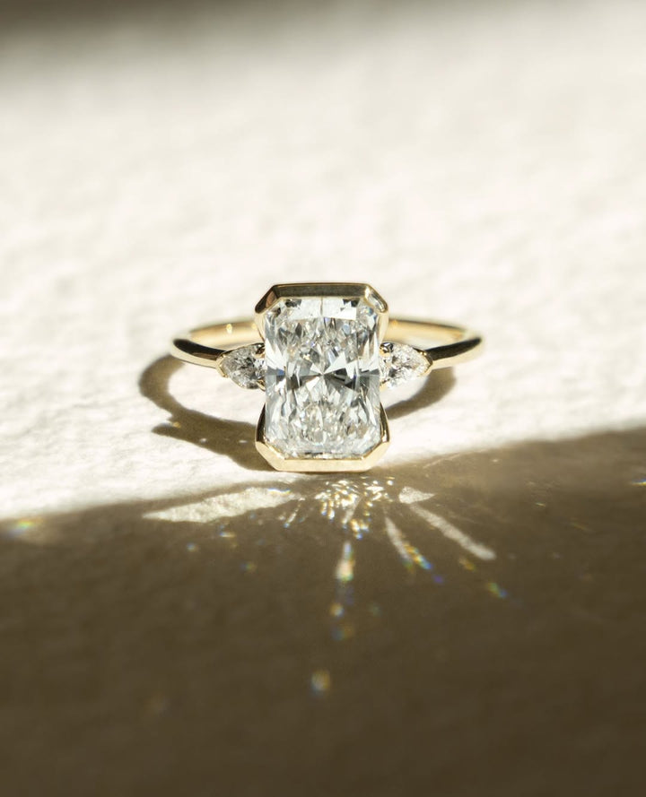 Radiant bezel engagement ring viewed from the side
