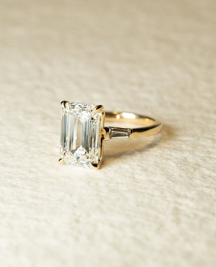 Emerald three stone engagement ring with certified lab grown diamond