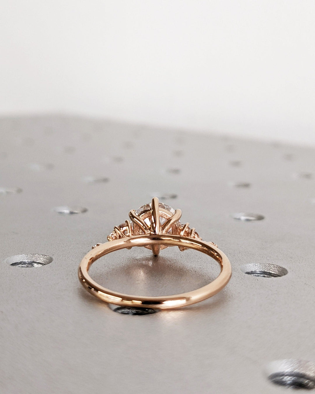 Round cluster engagement ring viewed from the side