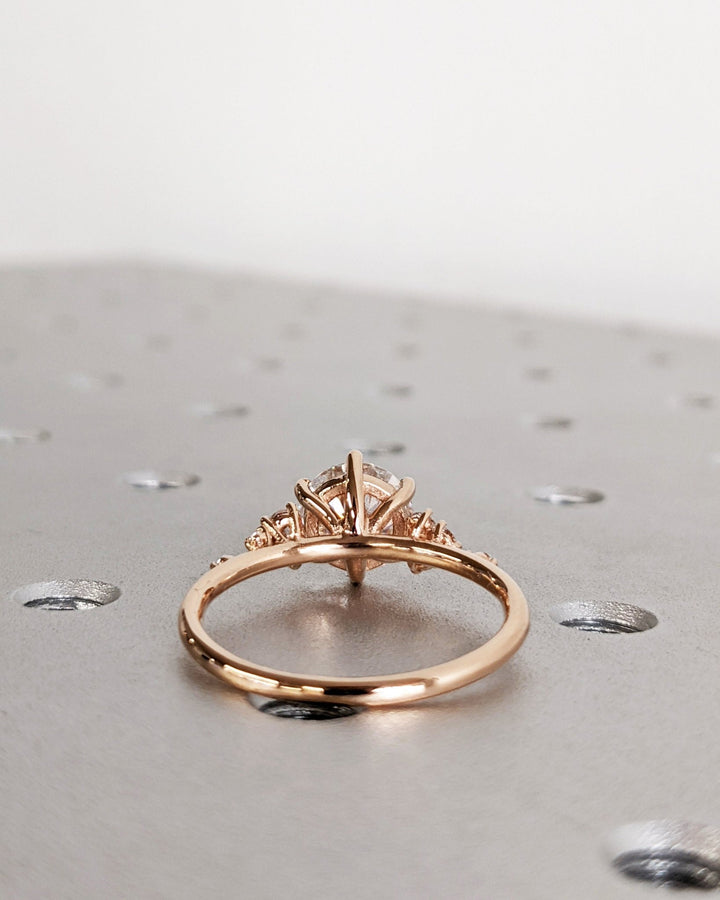 Round cluster engagement ring viewed from the side