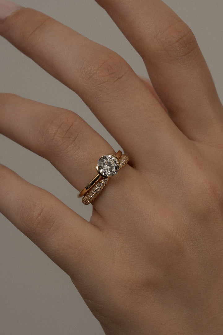 Angled view of round cut diamond in bezel setting