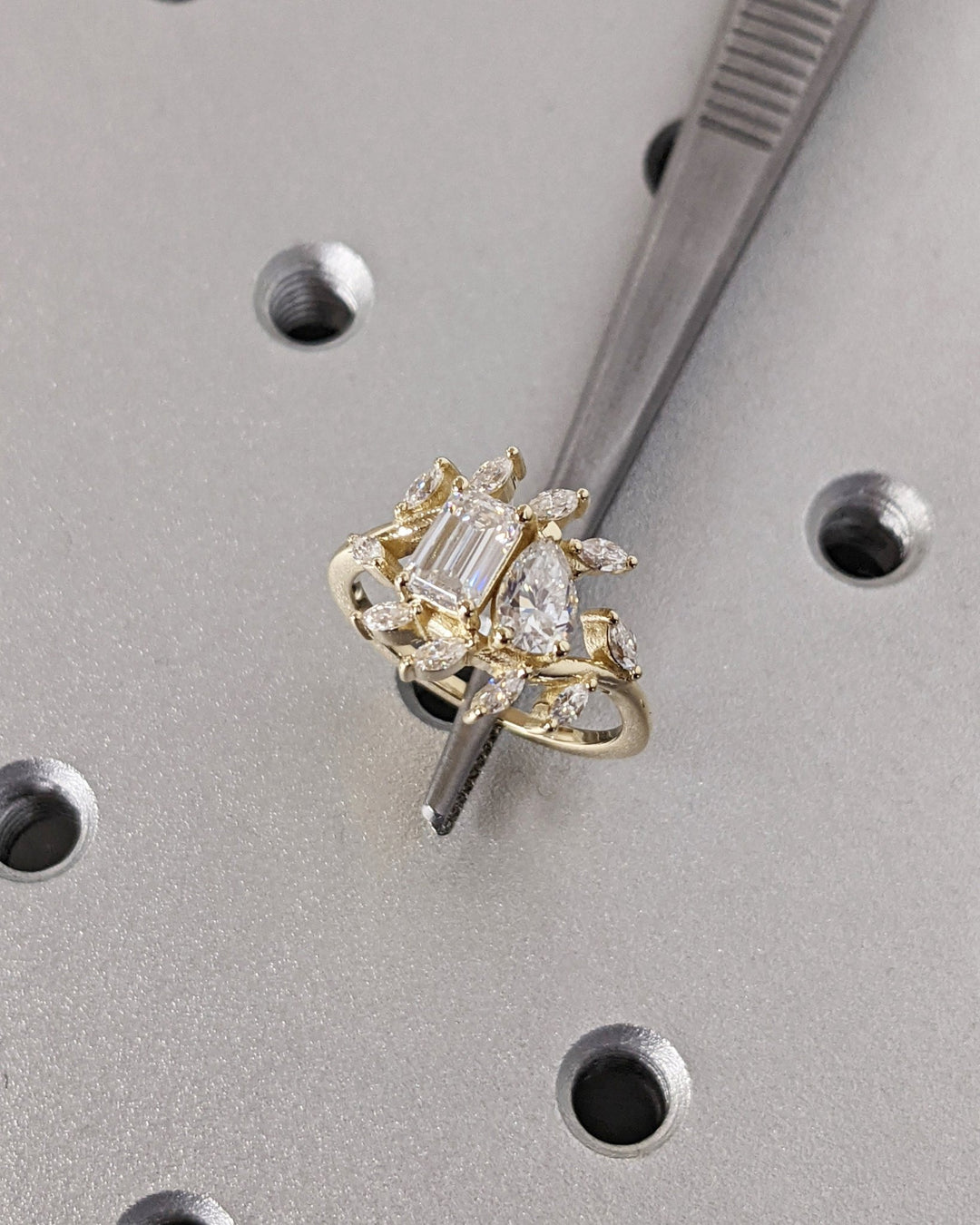Pear cut cluster engagement ring with IGI certified center diamond