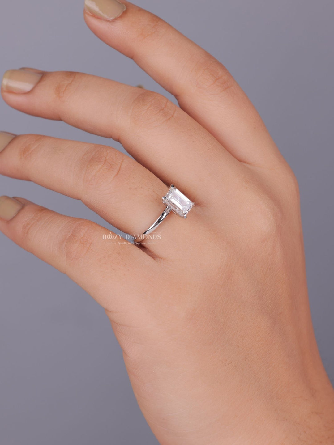 Emerald solitaire lab grown diamond ring side profile in gold setting