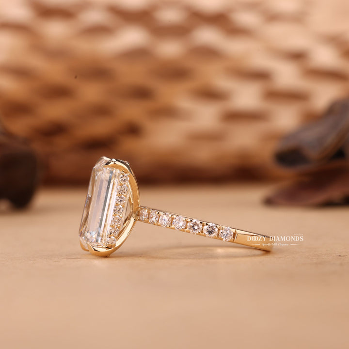 Emerald cut engagement ring shown with authenticity certificate