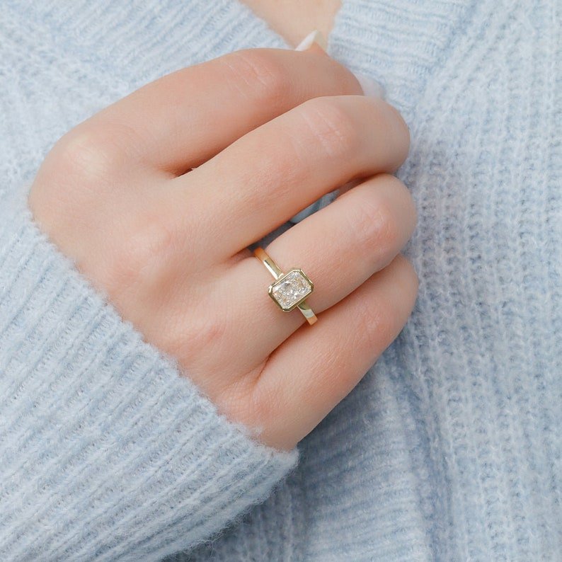 Macro shot of radiant cut diamond facets in bezel ring setting