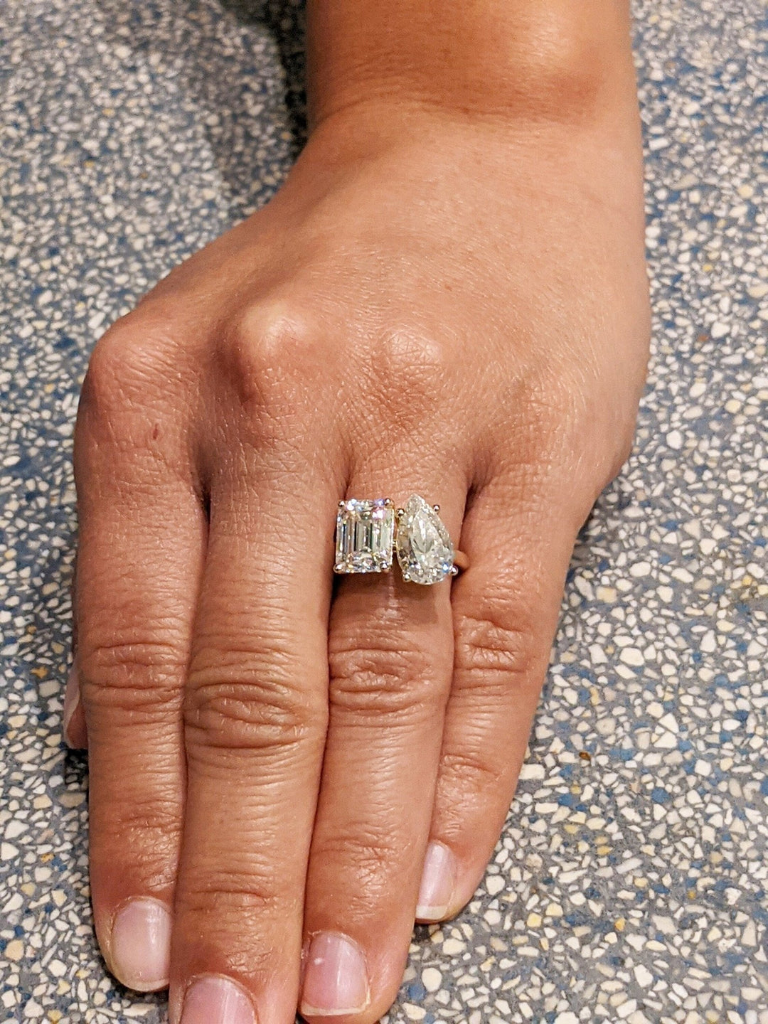 Pear solitaire engagement ring shown on hand for true-to-life sizing