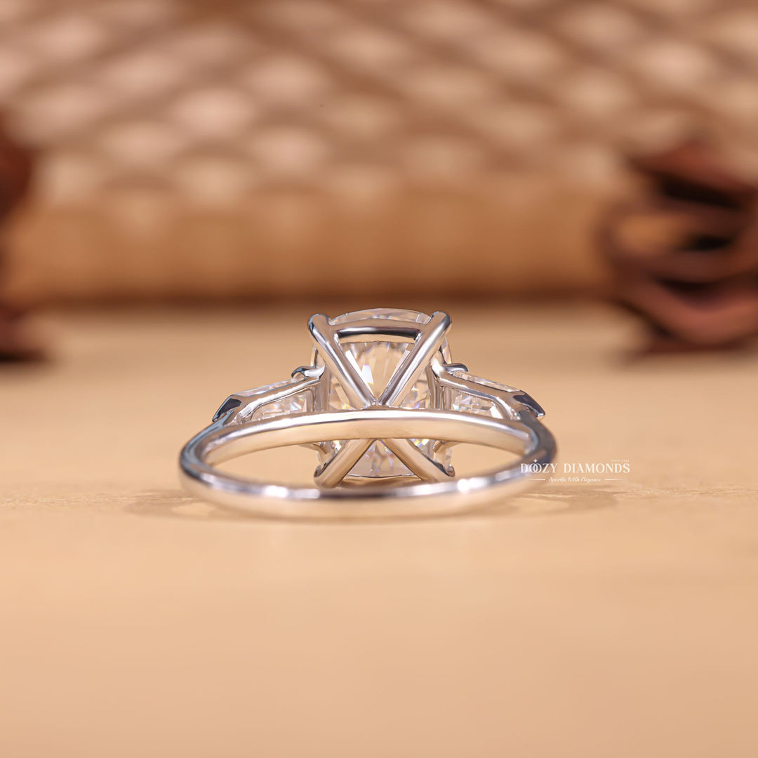 Detailed close-up of cushion three stone diamond engagement ring