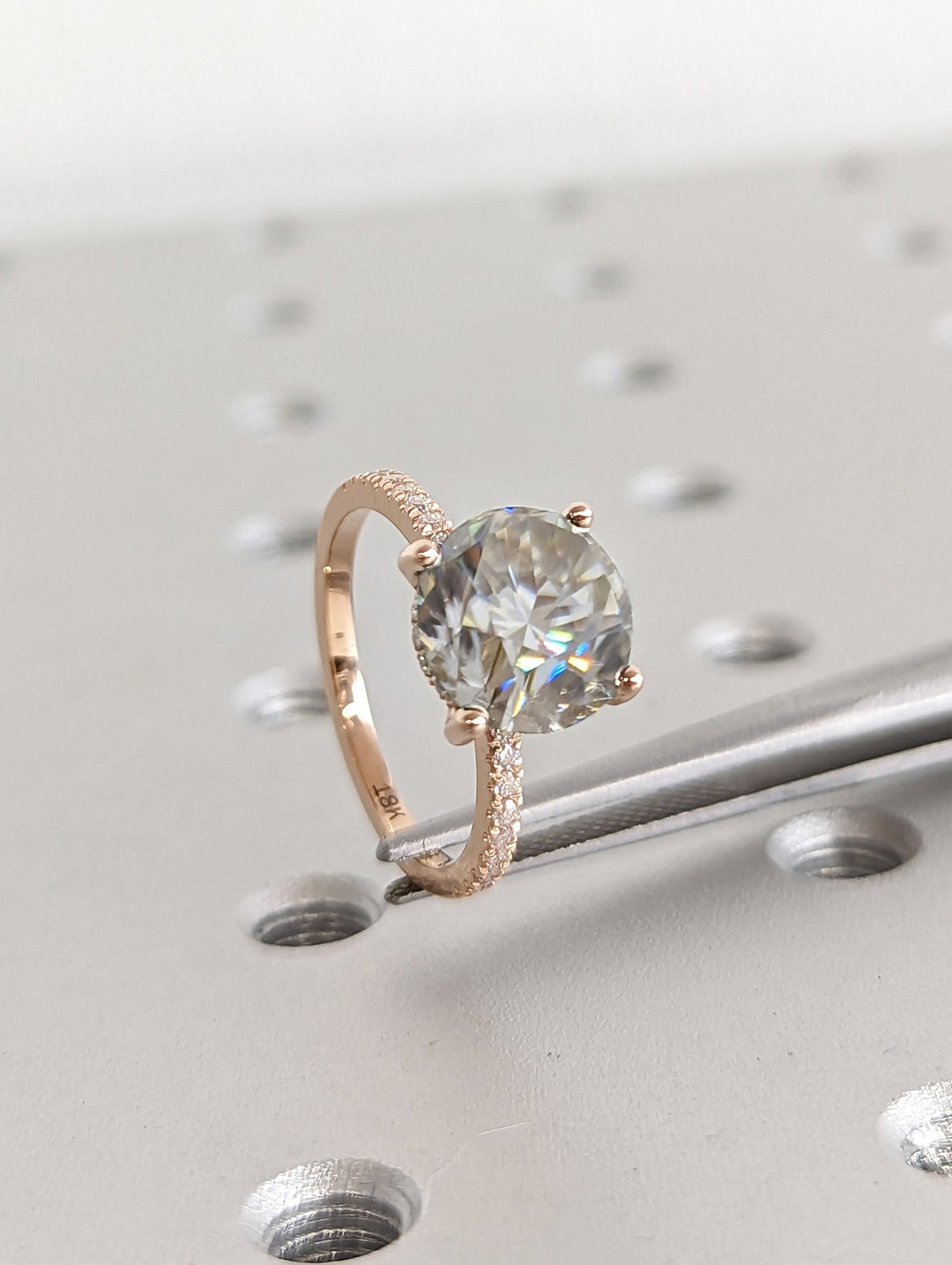 Macro shot of round cut diamond facets in hidden halo ring setting
